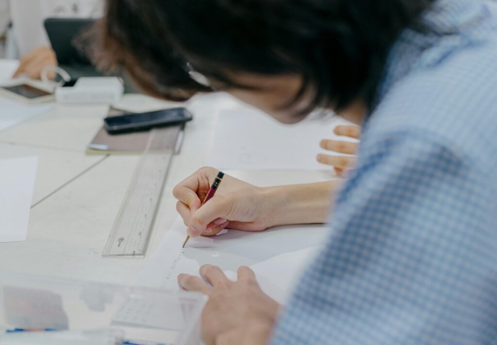 Close-up of students engaging in creative work during an art session in a Tokyo classroom.