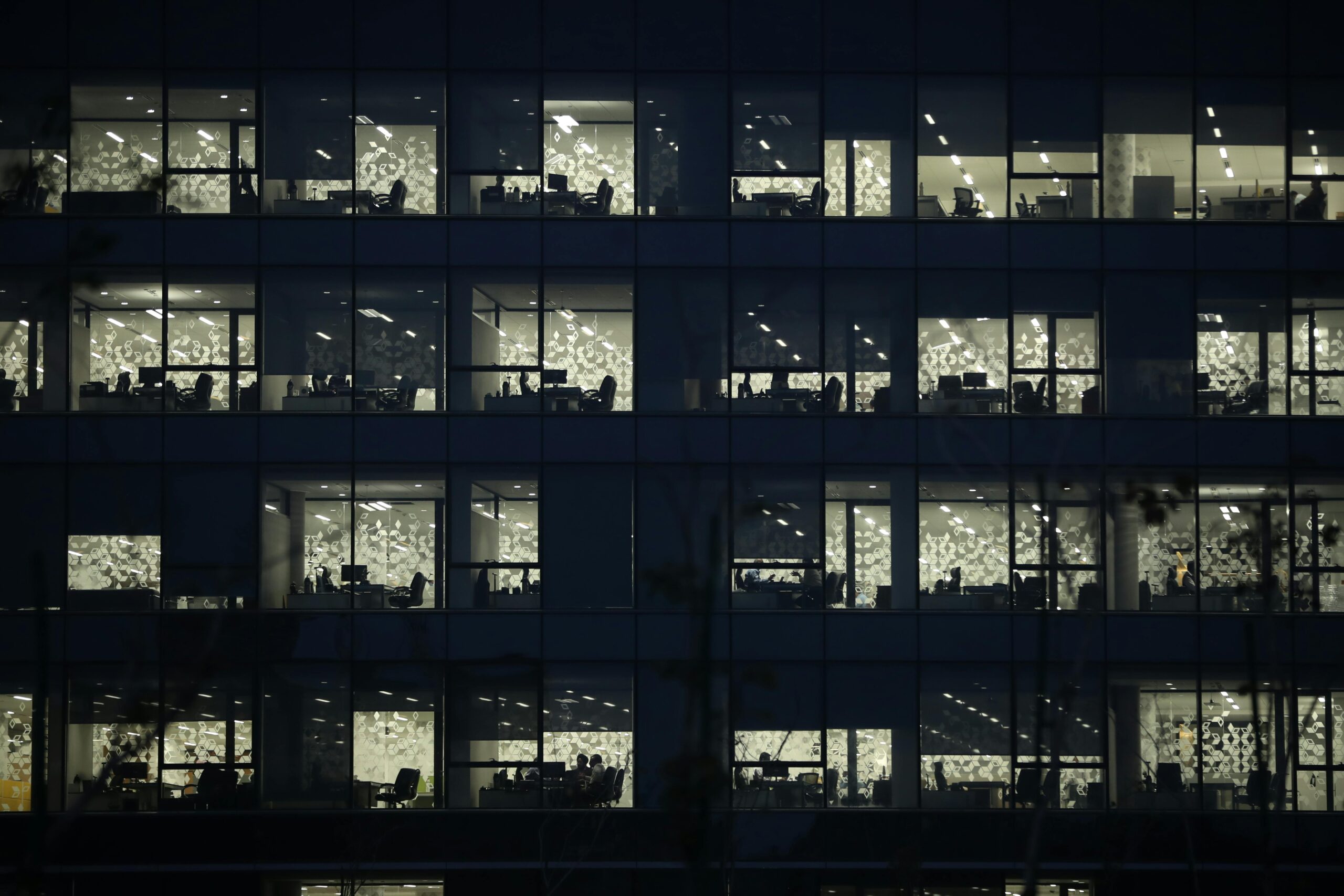 View of an office building at night with illuminated windows in Gandhinagar, India.